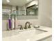 Bathroom sink with modern fixtures, illuminated mirror and convenient toothbrush holder at 1545 Ashley River Rd # 3K, Charleston, SC 29407