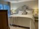 Relaxing bedroom features soft lighting, a decorative mirror, and a comfortable bed with plush pillows at 1545 Ashley River Rd # 3K, Charleston, SC 29407