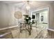 Bright dining room featuring a glass table, clear chairs, and a stylish geometric chandelier at 1545 Ashley River Rd # 3K, Charleston, SC 29407