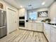 Bright kitchen features stainless steel appliances, white cabinetry, and wood grain flooring at 1545 Ashley River Rd # 3K, Charleston, SC 29407