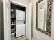 Laundry closet with stacked washer and dryer with shelving at 1545 Ashley River Rd # 3K, Charleston, SC 29407
