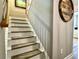 A staircase with carpeted steps and white risers, ascending to the upper level at 1545 Ashley River Rd # 3K, Charleston, SC 29407