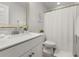 This bathroom features a white vanity, toilet, and shower with stylish decor at 1549 Moss Spring Rd, Mount Pleasant, SC 29466