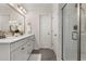 Bright bathroom featuring double sink vanity, framed mirror, white cabinets, and a glass-enclosed shower at 1549 Moss Spring Rd, Mount Pleasant, SC 29466
