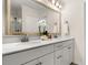 Elegant bathroom with double vanity, white marble counters, large mirror, and walk-in shower in the background at 1549 Moss Spring Rd, Mount Pleasant, SC 29466