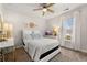 Bright bedroom with a ceiling fan, a white bed, and a dresser with a TV, creating a cozy space at 1549 Moss Spring Rd, Mount Pleasant, SC 29466