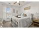 Cozy bedroom with a metal-framed bed, ceiling fan, and bright natural light at 1549 Moss Spring Rd, Mount Pleasant, SC 29466