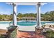 View of the large community pool with brick and pillar entrance, picnic tables, and covered area at 1549 Moss Spring Rd, Mount Pleasant, SC 29466