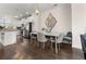 Bright dining area with dark wood floors, modern lighting and stainless steel appliances in the background at 1549 Moss Spring Rd, Mount Pleasant, SC 29466