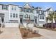 Stylish townhome exterior featuring attached garages and well-maintained landscaping at 1549 Moss Spring Rd, Mount Pleasant, SC 29466