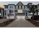 Evening shot of townhomes with garages, driveways, and landscape at 1549 Moss Spring Rd, Mount Pleasant, SC 29466