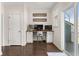Well-lit home office nook with custom built-in desk, modern design, and balcony access at 1549 Moss Spring Rd, Mount Pleasant, SC 29466