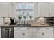 Close up of kitchen sink with stainless steel appliances and granite countertops at 1549 Moss Spring Rd, Mount Pleasant, SC 29466