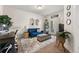 Comfortable living room with stylish decor, blue sofa and plenty of natural light at 1549 Moss Spring Rd, Mount Pleasant, SC 29466