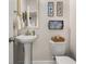 Cozy powder room with pedestal sink, stylish decor, and ample space at 1549 Moss Spring Rd, Mount Pleasant, SC 29466
