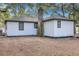 View of the house from backyard with a wooded area at 1652 Larry St, North Charleston, SC 29405