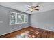 Cozy bedroom featuring gleaming hardwood floors, a ceiling fan, and plenty of natural light at 1652 Larry St, North Charleston, SC 29405