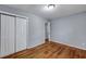 A bedroom features hardwood floors, light gray walls, and white closet doors at 1652 Larry St, North Charleston, SC 29405