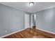 A clean bedroom features hardwood flooring, light gray walls, and a door leading to another room at 1652 Larry St, North Charleston, SC 29405