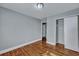 A bedroom features hardwood floors, light gray walls, and a closet with white sliding doors at 1652 Larry St, North Charleston, SC 29405