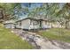 Charming home with a long driveway, fenced yard, and storage shed in backyard at 1652 Larry St, North Charleston, SC 29405
