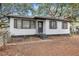 This charming home features a freshly painted exterior, classic shutters, and cozy porch at 1652 Larry St, North Charleston, SC 29405
