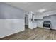 The kitchen features white cabinetry, wood laminate flooring, and stainless steel appliances at 1652 Larry St, North Charleston, SC 29405