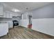 Well-lit kitchen featuring updated flooring, white cabinets, stainless steel range, and updated paint at 1652 Larry St, North Charleston, SC 29405