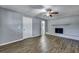 Cozy living room with a painted brick fireplace, ceiling fan, and wood-look flooring at 1652 Larry St, North Charleston, SC 29405