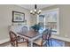 Dining room with hardwood floors and a chandelier over a wooden table next to a large window at 1855 Halle Rd, Johns Island, SC 29455