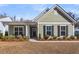 Charming single-story home featuring a covered porch, green siding, and well-maintained landscaping at 1855 Halle Rd, Johns Island, SC 29455