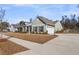 Exterior view of the home showcasing its well-manicured lawn, garage, and attractive green siding at 1855 Halle Rd, Johns Island, SC 29455