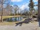 Community pond featuring a water fountain, walking path, and mature trees at 1855 Halle Rd, Johns Island, SC 29455