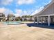 A community pool with lounge chairs, a pool house, and community homes in background at 1855 Halle Rd, Johns Island, SC 29455