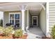 Inviting covered porch with seating area offers a relaxing outdoor space at the home's entrance at 1855 Halle Rd, Johns Island, SC 29455
