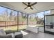 Screened porch featuring seating area, a grill, and fenced in back yard at 1855 Halle Rd, Johns Island, SC 29455