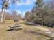 A beautiful community walking path featuring mature trees, picnic tables, and well-maintained landscaping at 1855 Halle Rd, Johns Island, SC 29455