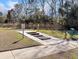 Outdoor walking trail featuring stepping stones, manicured grass, and access to neighborhood amenities at 1855 Halle Rd, Johns Island, SC 29455
