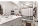 Clean bathroom with a large vanity, ample counter space, and a shower-tub combo with a decorative shower curtain at 187 Granton Edge Ln, Summerville, SC 29486