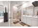 Primary bathroom with double sink vanity, tiled shower with glass door, large mirror, and tiled floor at 187 Granton Edge Ln, Summerville, SC 29486