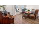 A formal dining room featuring hardwood floors, a wooden table, and several windows offering natural light at 187 Granton Edge Ln, Summerville, SC 29486