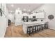 Bright kitchen with white cabinetry, quartz countertops, stainless steel appliances, and seating at the breakfast bar at 187 Granton Edge Ln, Summerville, SC 29486