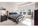 Primary bedroom with tray ceiling, neutral carpet, large windows overlooking backyard, and ensuite bathroom at 187 Granton Edge Ln, Summerville, SC 29486