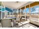 Cozy screened porch with ceiling fan and comfortable seating overlooking a serene lake view at 187 Granton Edge Ln, Summerville, SC 29486