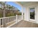 Balcony view with white railings overlooking a serene street and lush greenery at 1918 Essex Farms Dr, Charleston, SC 29414