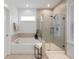 Bright bathroom with a soaking tub, tiled shower, and a window with plantation shutters at 1918 Essex Farms Dr, Charleston, SC 29414