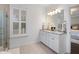 Bathroom showcasing a double vanity with marble countertop and stylish plantation shutters at 1918 Essex Farms Dr, Charleston, SC 29414
