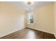 Bedroom highlighting hardwood floors, a window with plantation shutters, and neutral paint at 1918 Essex Farms Dr, Charleston, SC 29414