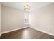 An empty bedroom featuring light-colored walls, hardwood floors and a window with white shutters at 1918 Essex Farms Dr, Charleston, SC 29414