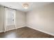 Bedroom featuring hardwood floors, a window with curtains and plantation shutters, and neutral paint at 1918 Essex Farms Dr, Charleston, SC 29414